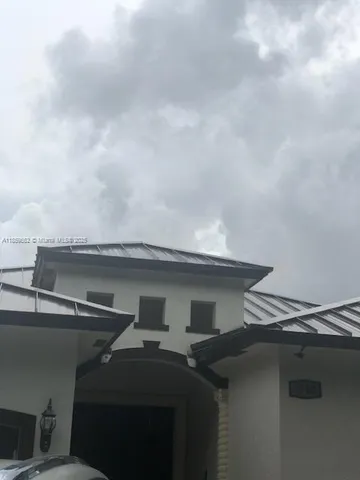 a spacious bedroom with a bed and a chandelier