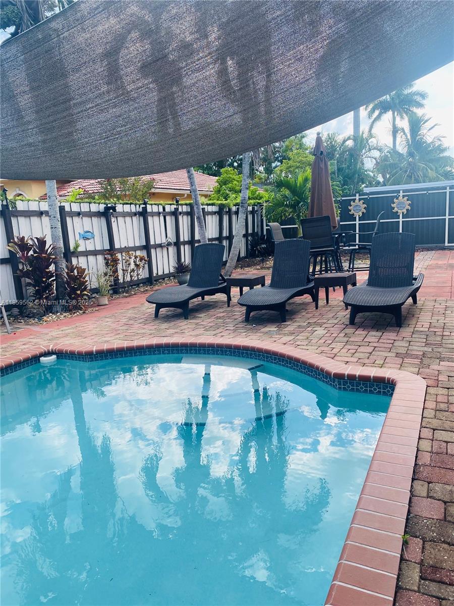 7760 Northwest 163rd Street Miami Lakes, FL 33016 - Photo 56 of 68 a swimming pool with outdoor seating