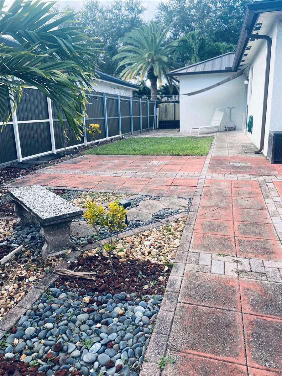 7760 Northwest 163rd Street Miami Lakes, FL 33016 - Photo 63 of 68 a view of a backyard with a garden