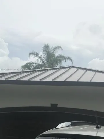 a living room with furniture a flat screen tv and a potted plant