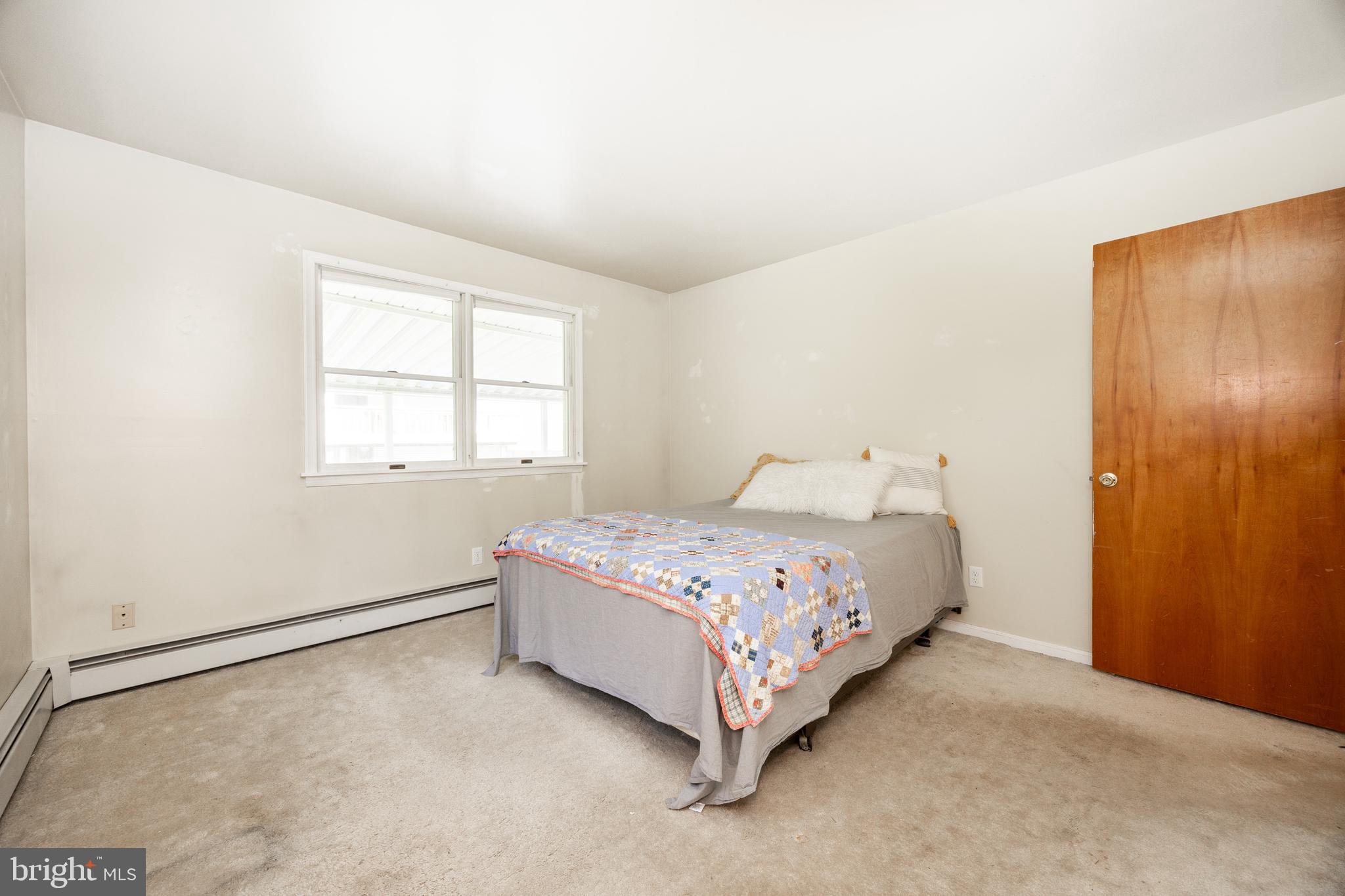 5509 Hoppenville Road Green Lane, PA 18054 - Photo 12 of 70 a bedroom with a bed and window