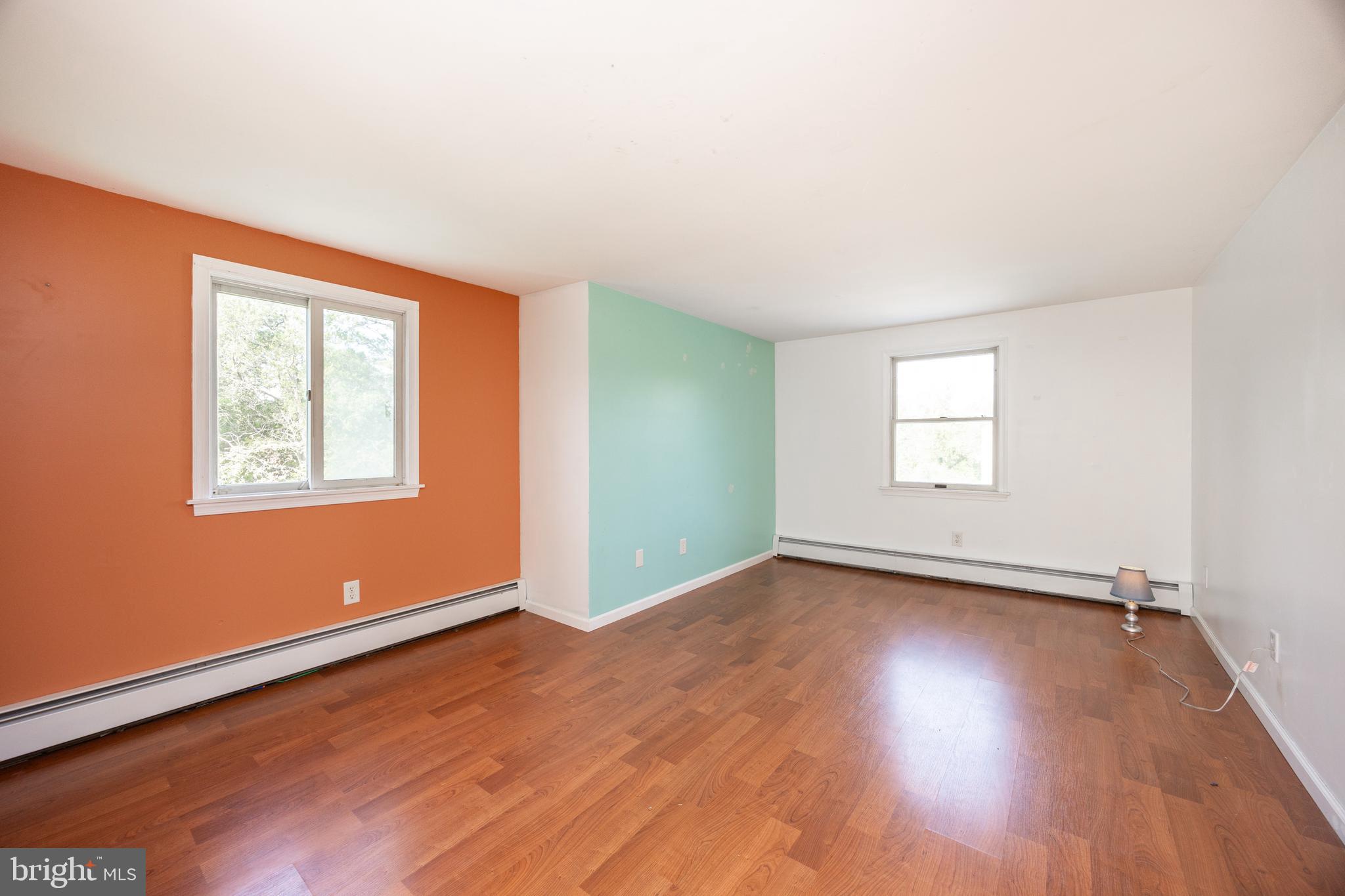 5509 Hoppenville Road Green Lane, PA 18054 - Photo 20 of 70 an empty room with wooden floor and windows