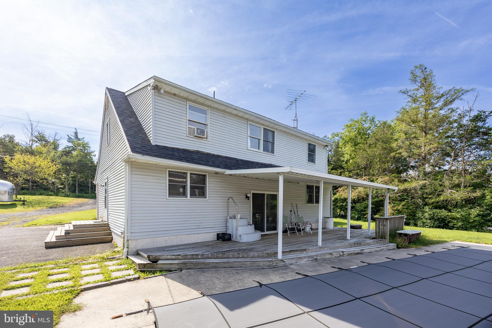 5509 Hoppenville Road Green Lane, PA 18054 - Photo 23 of 70 a backyard of a house with table and chairs