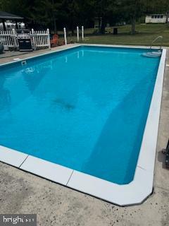 5509 Hoppenville Road Green Lane, PA 18054 - Photo 26 of 70 a view of a swimming pool with an outdoor space and seating area