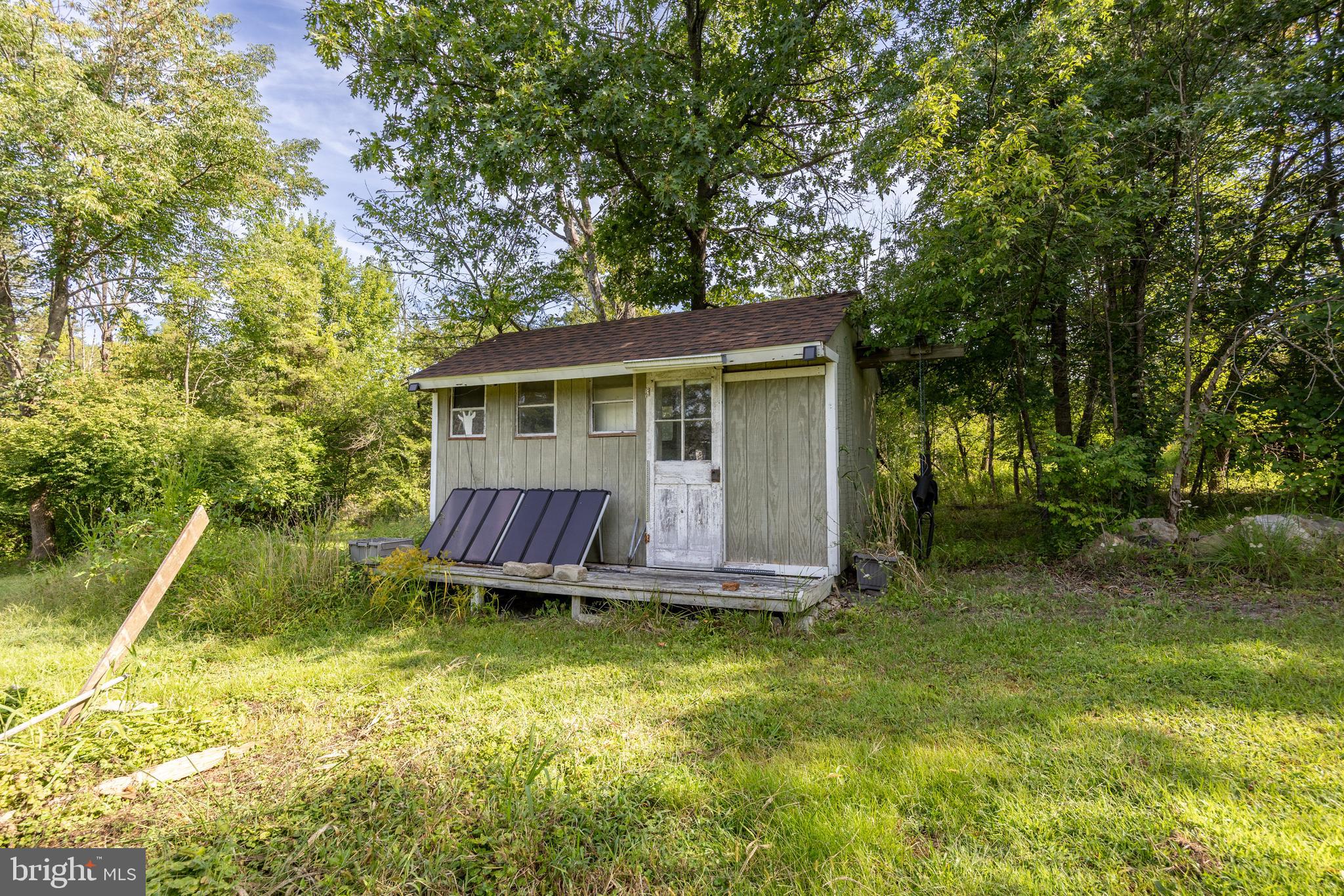 5509 Hoppenville Road Green Lane, PA 18054 - Photo 53 of 70 a view of a backyard with table and chairs a barbeque and large trees