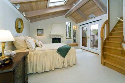 86 Prospect Avenue Sausalito, CA 94965 - Photo 8 of 9 a spacious bedroom with a bed and a lamp