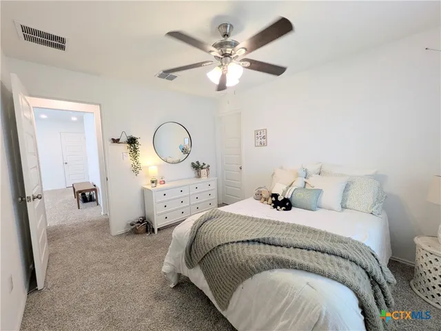 a bedroom with bed and a chandelier