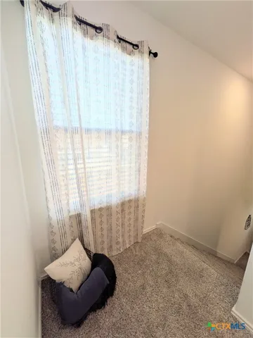 a living room with furniture and a shower