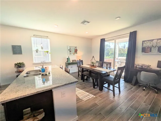 a view of a dining room with furniture window and outside view