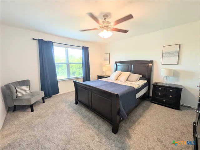 a bedroom with a bed and a couch