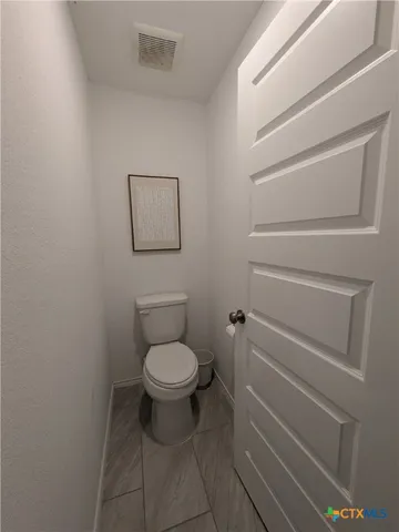 a bathroom with a toilet and a vanity