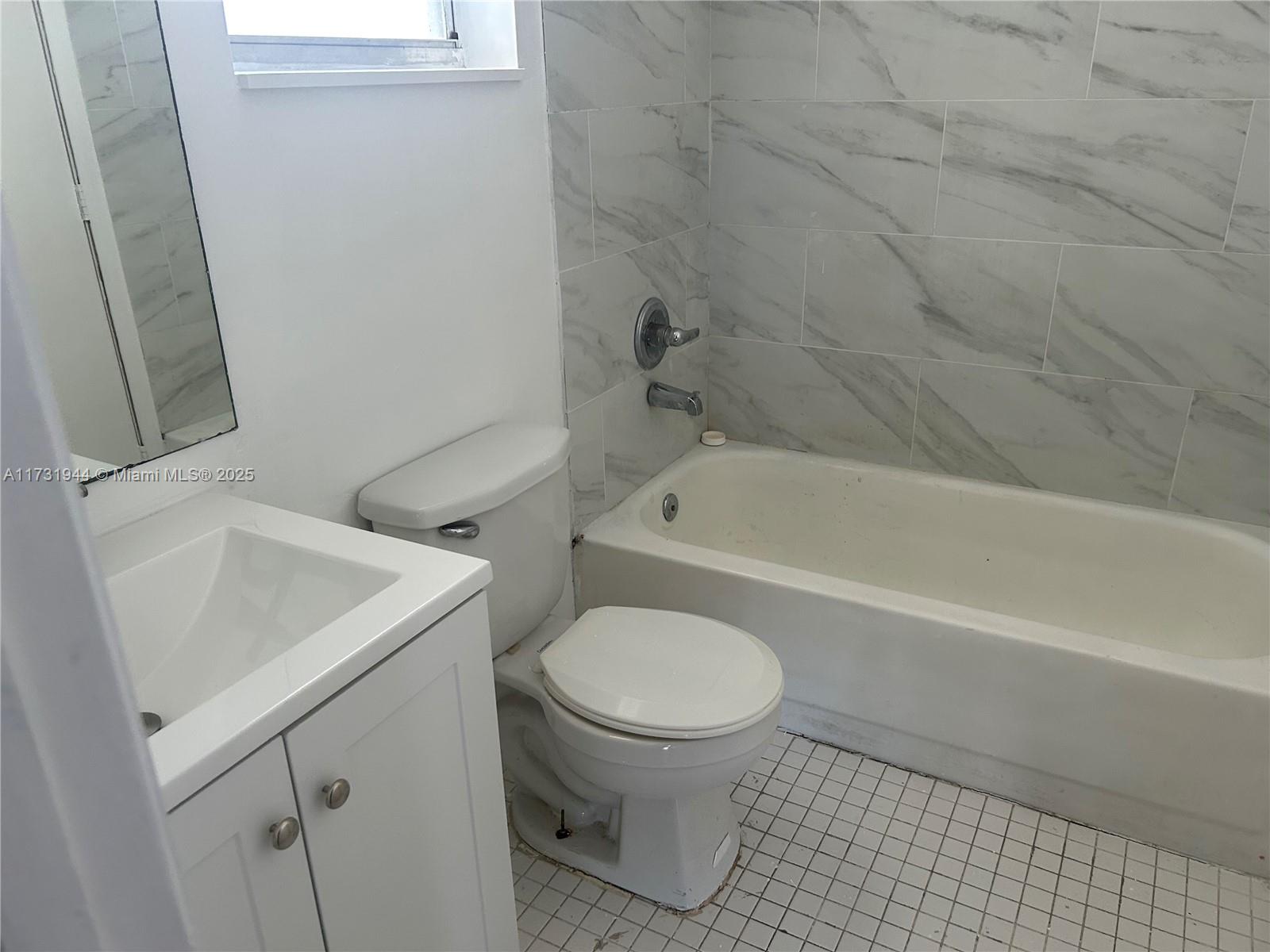Ives Estates Miami, FL 33179 - Photo 11 of 19 a bathroom with a sink a toilet and bathtub