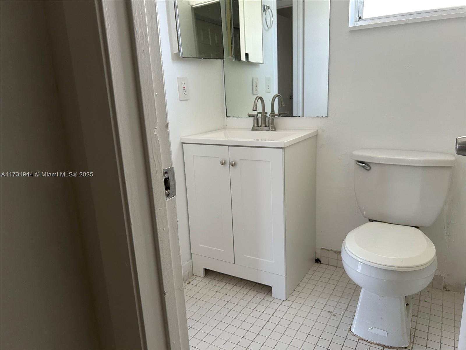 Ives Estates Miami, FL 33179 - Photo 12 of 19 a bathroom with a toilet sink and mirror