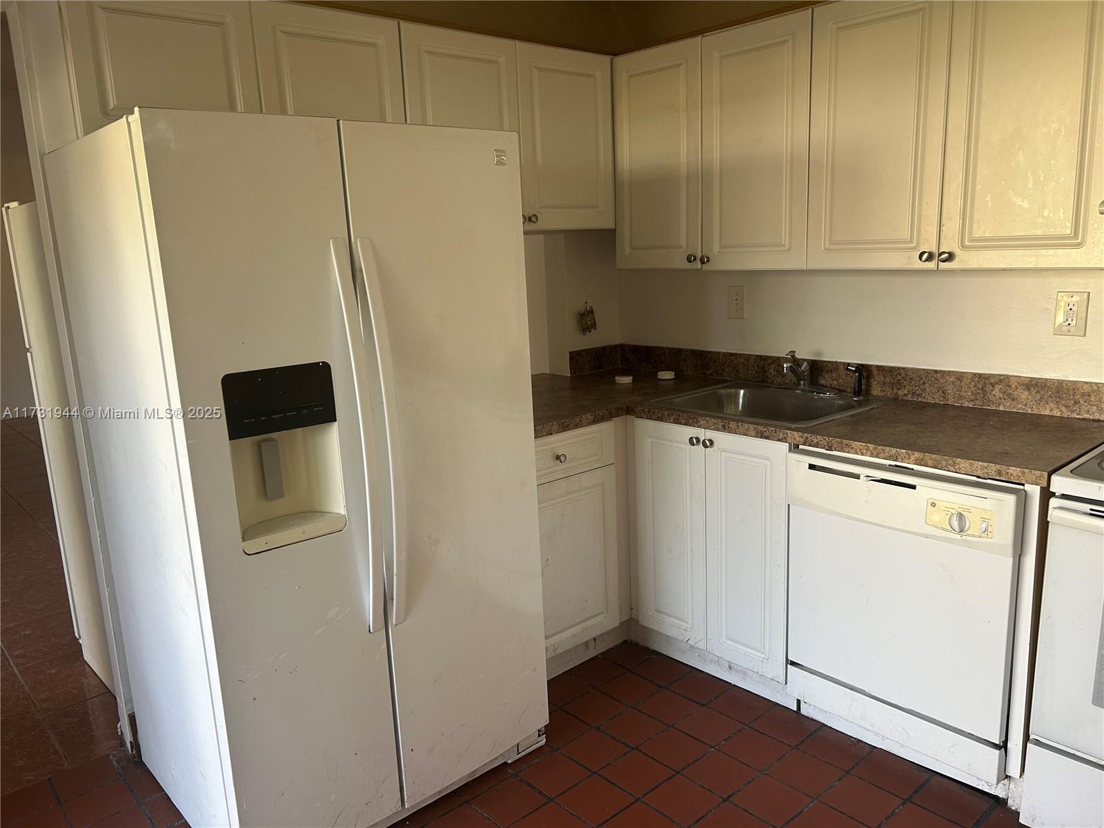Ives Estates Miami, FL 33179 - Photo 15 of 19 a white refrigerator freezer sitting inside of a kitchen