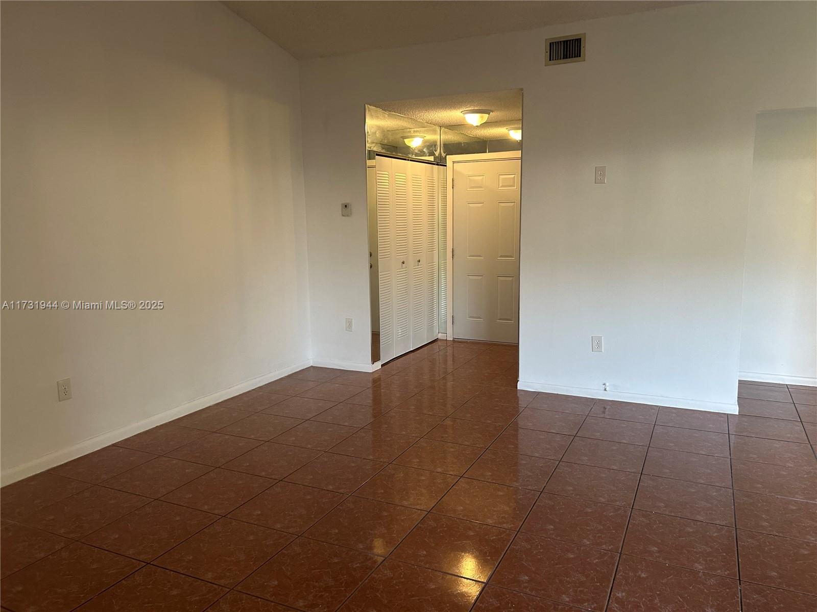 Ives Estates Miami, FL 33179 - Photo 4 of 19 an empty room with wooden floor and windows