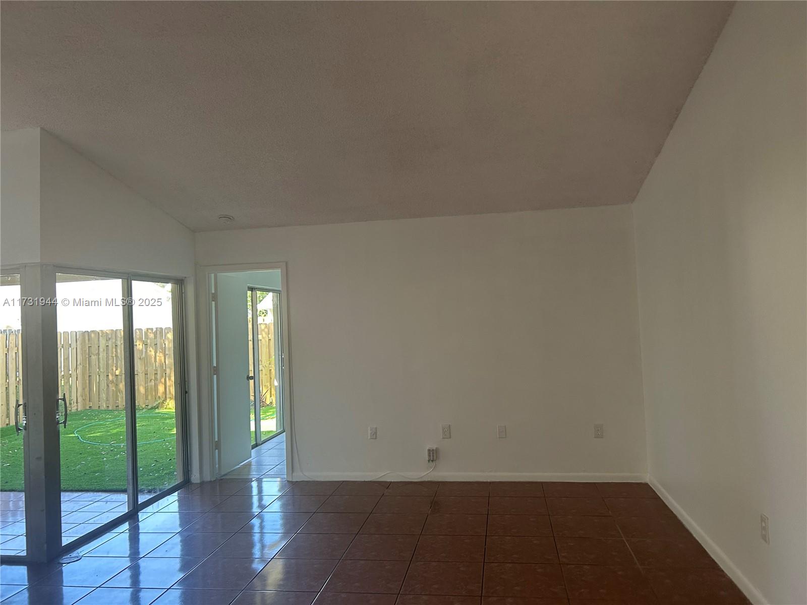 Ives Estates Miami, FL 33179 - Photo 5 of 19 an empty room with wooden floor and windows