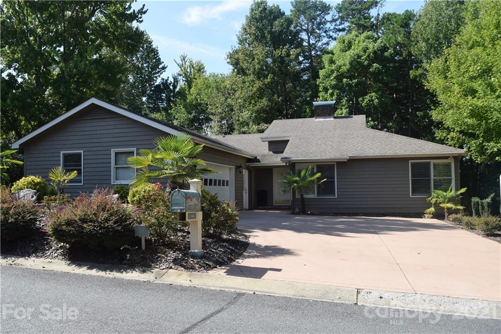 a front view of house with yard outdoor seating and yard in the back