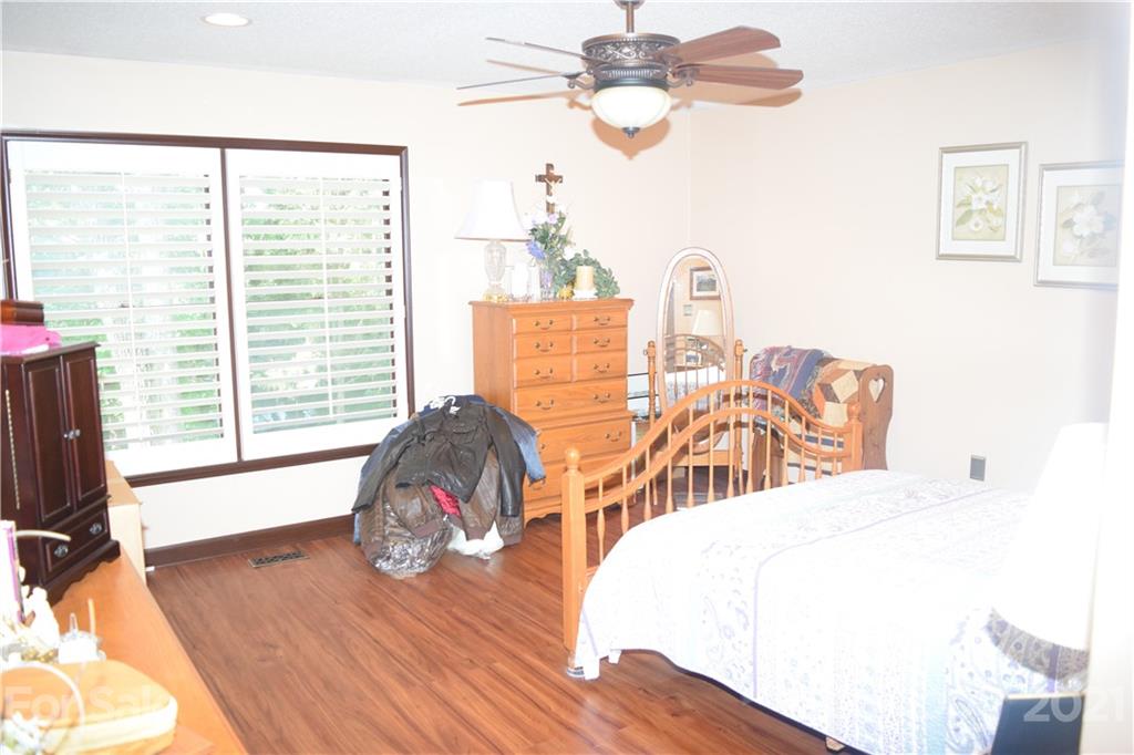 18 Shipmaster Court Lake Wylie, SC 29710 - Photo 17 of 34 a bedroom with a bed and wooden floor