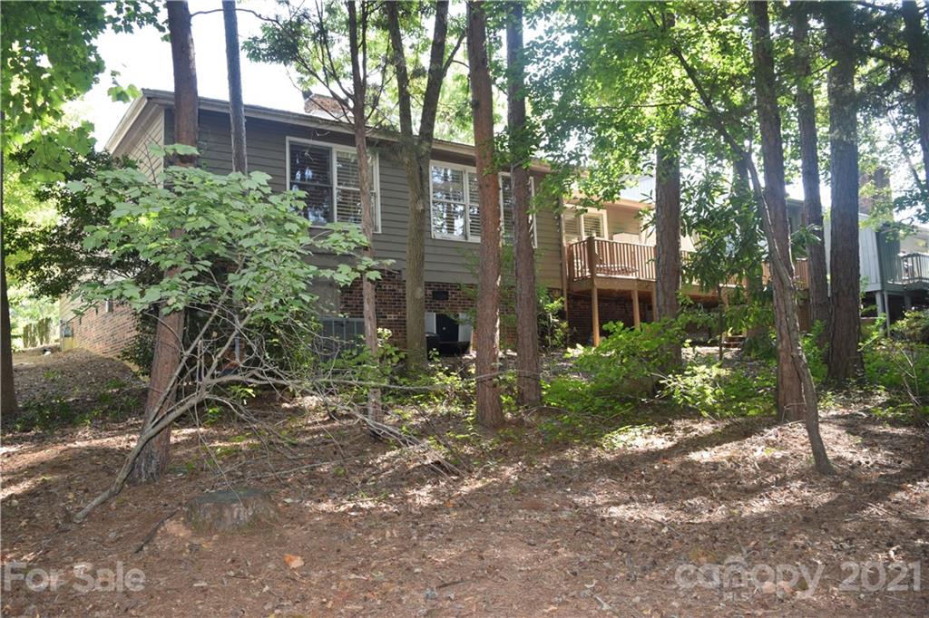 18 Shipmaster Court Lake Wylie, SC 29710 - Photo 32 of 34 a view of a brick house with a yard and large trees