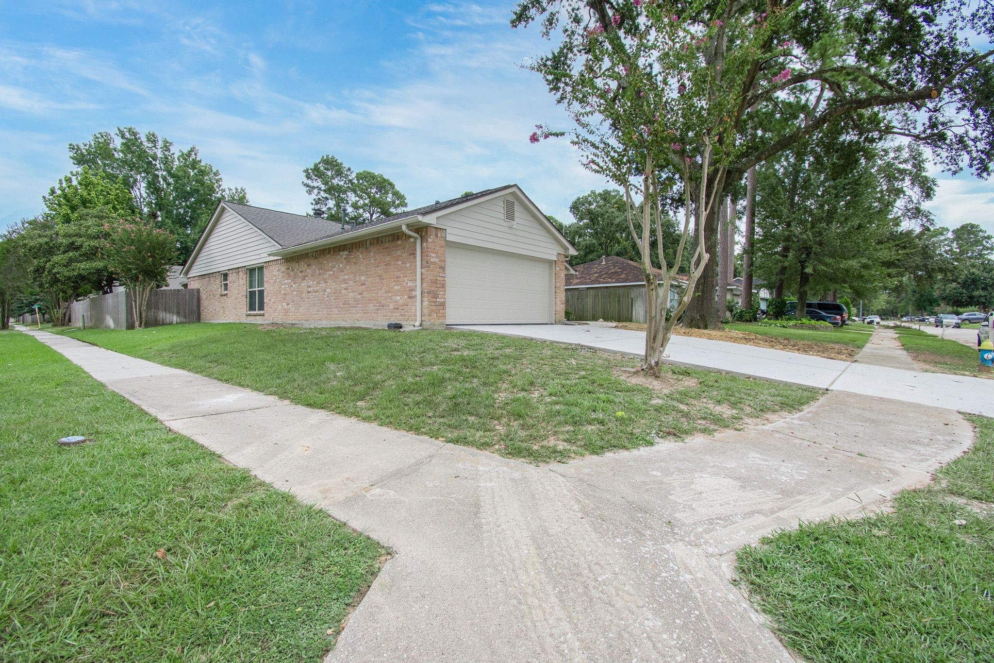 17330 Modbury Drive Spring, TX 77379 - Photo 1 of 30 Charming brick home on a corner lot with a spacious NEW driveway, offering great curb appeal in a serene neighborhood setting.