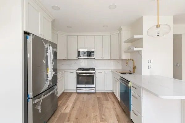 a kitchen with a refrigerator a sink and a stove