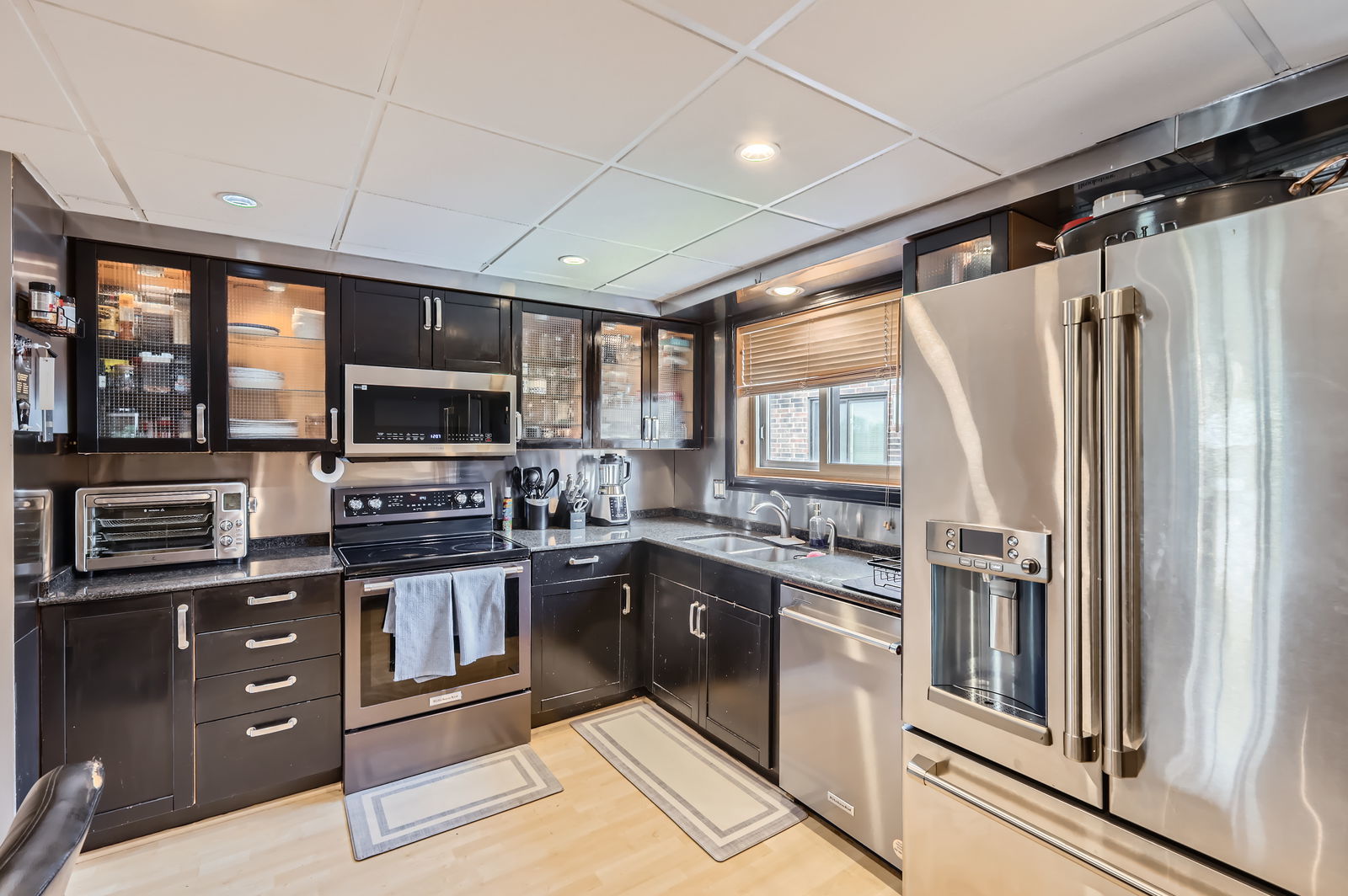 953 North Rohlwing Road, Unit 201A Addison, IL 60101 - Photo 5 of 11 a kitchen with stainless steel appliances granite countertop a refrigerator and a stove top oven