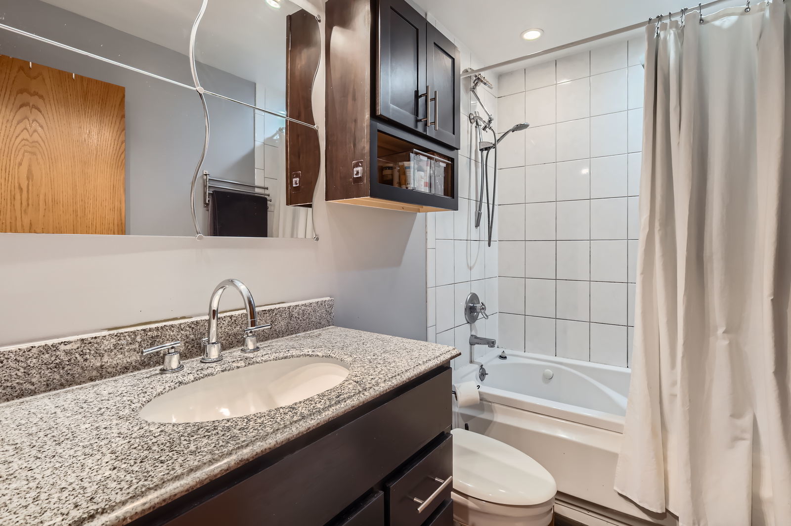 953 North Rohlwing Road, Unit 201A Addison, IL 60101 - Photo 8 of 11 a bathroom with a granite countertop sink toilet and shower