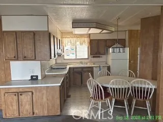 an empty room with windows and cabinet