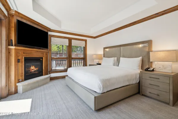 a spacious bedroom with a bed and a fireplace