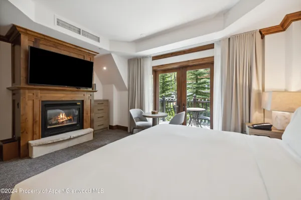 a large bedroom with a bed and a fireplace