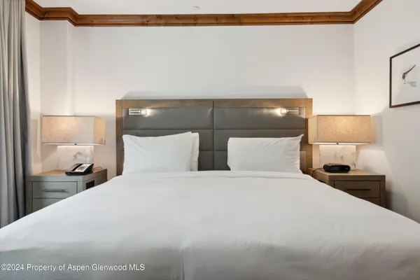 a large white bed in a white lamp