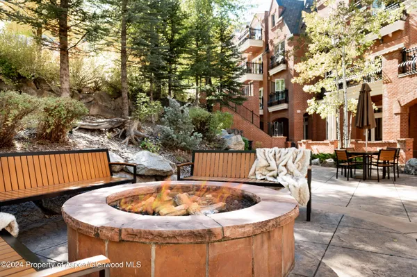 a roof deck with couches and wooden fence