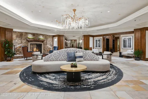 a view of a lobby with a chandelier and wooden floor