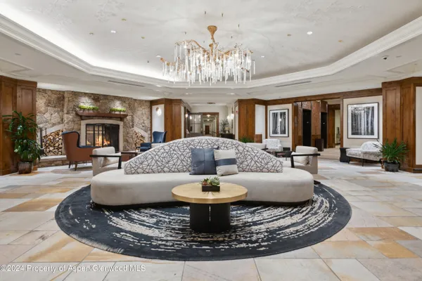 a view of a lobby with a chandelier and wooden floor
