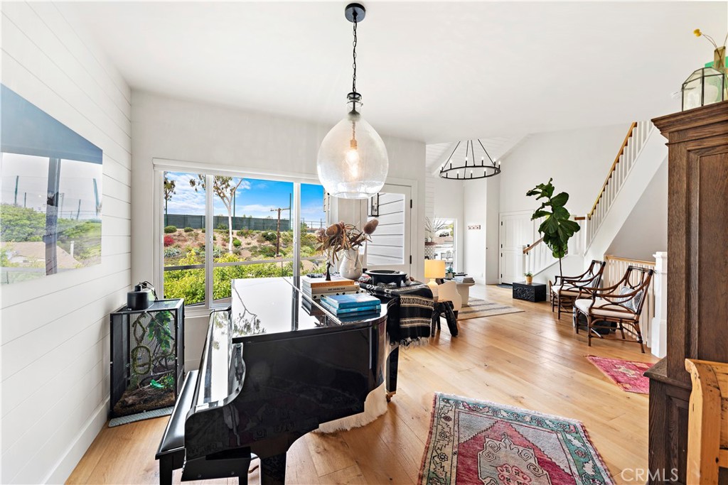 721 Browncroft Road Laguna Beach, CA 92651 - Photo 13 of 42 a living room with furniture a rug a chandelier and a large window