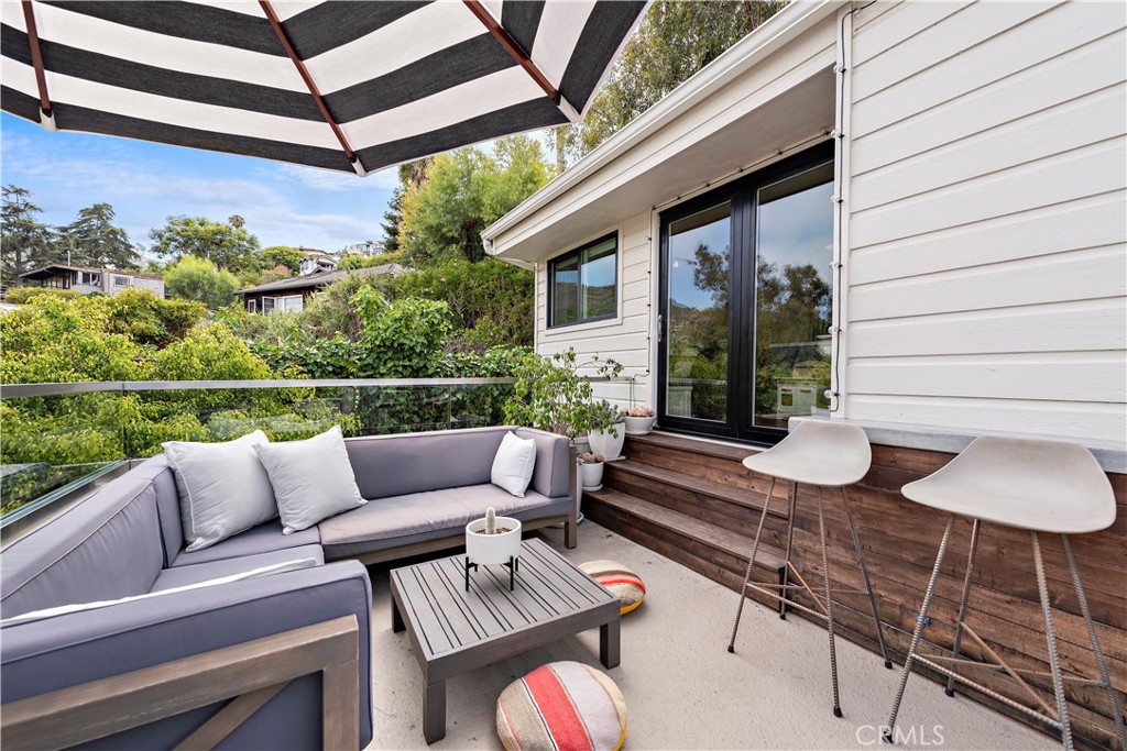 721 Browncroft Road Laguna Beach, CA 92651 - Photo 20 of 42 a view of a patio with couches chairs and a potted plant