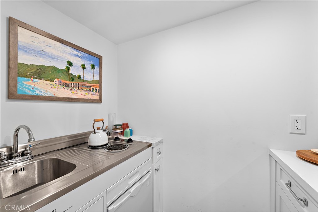 721 Browncroft Road Laguna Beach, CA 92651 - Photo 24 of 42 a kitchen with a sink and cabinets