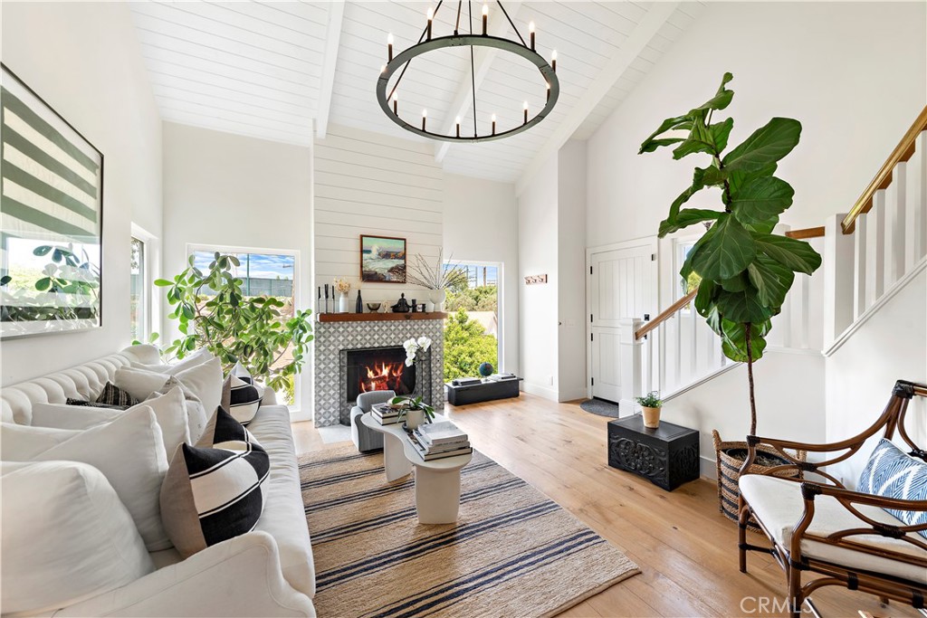 721 Browncroft Road Laguna Beach, CA 92651 - Photo 4 of 42 a living room with furniture a chandelier and a fireplace