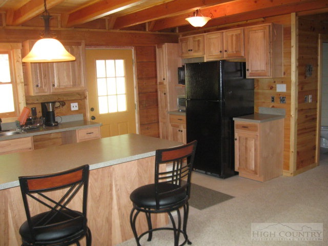 692 Mt Paron Road Deep Gap, NC 28618 - Photo 8 of 10 a kitchen with stainless steel appliances granite countertop a refrigerator and a stove