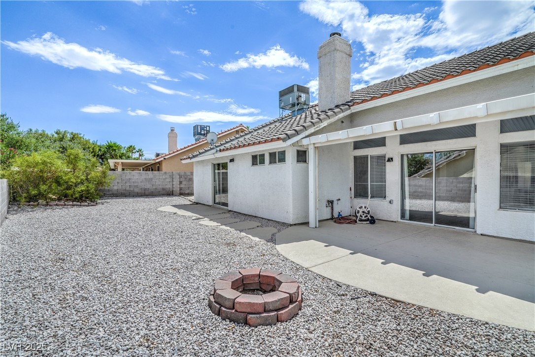 818 Coastal Beach Road Henderson, NV 89002 - Photo 32 of 39 Rear view of property featuring an outdoor fire pit, a tiled roof, stucco siding, and a patio area