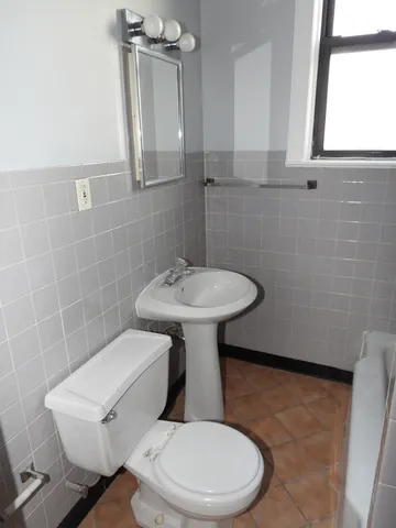 a white toilet sitting next to a white sink