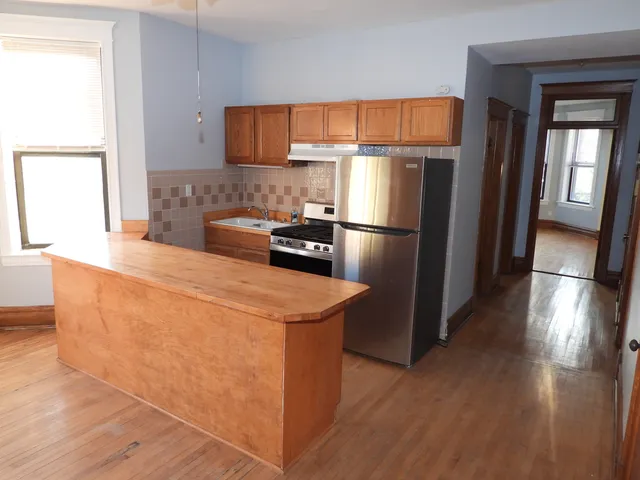 a kitchen with stainless steel appliances a refrigerator and a stove top oven