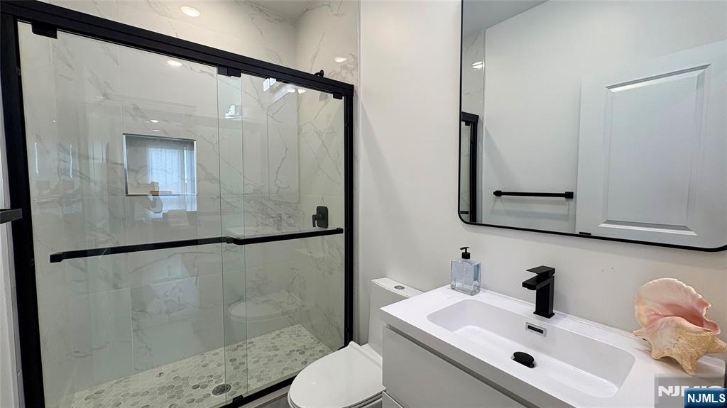 367 Devon Street, Unit 2 Kearny, NJ 07032 - Photo 24 of 30 a bathroom with a sink vanity mirror and toilet