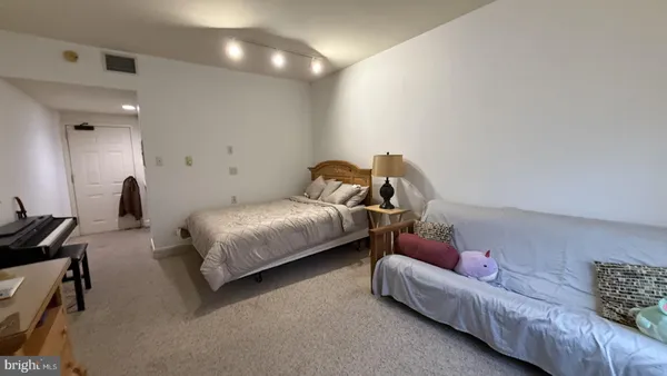a bedroom with bed and a couch