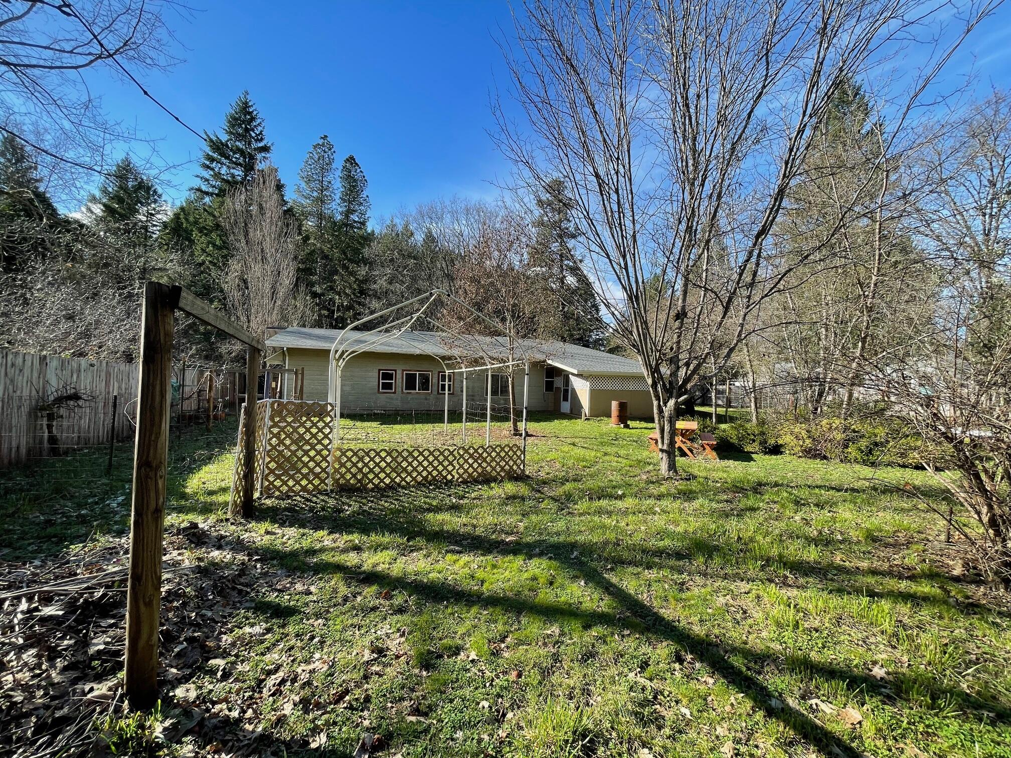 411 South Old Stage Road Cave Junction, OR 97523 - Photo 23 of 39 a front view of a house with a yard