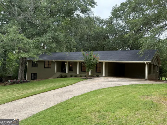 a front view of a house with yard and green space