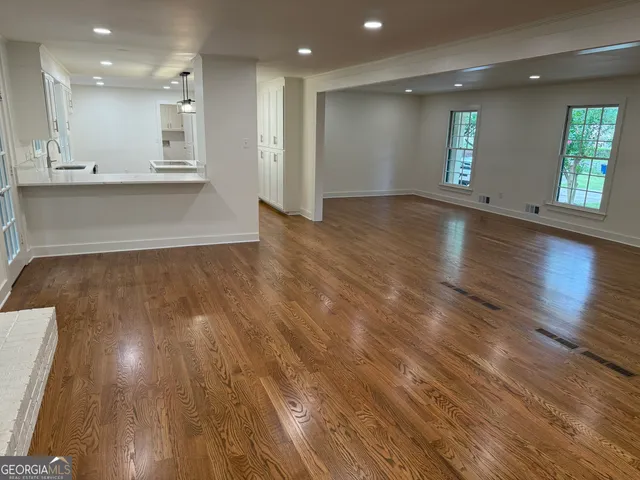 a view of kitchen and kitchen with wooden floor