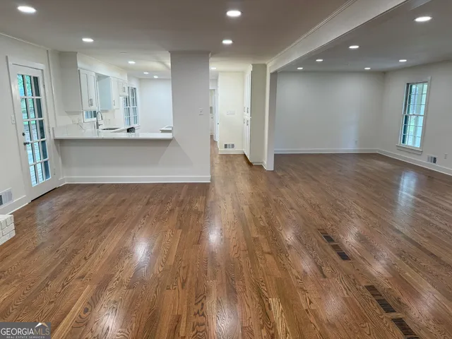 a living room with a fireplace and a wooden floor