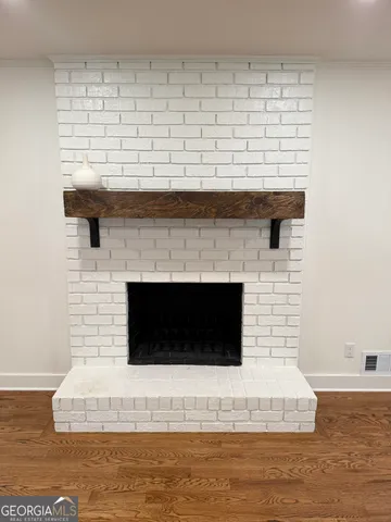 a view of a kitchen with wooden floor and a sink