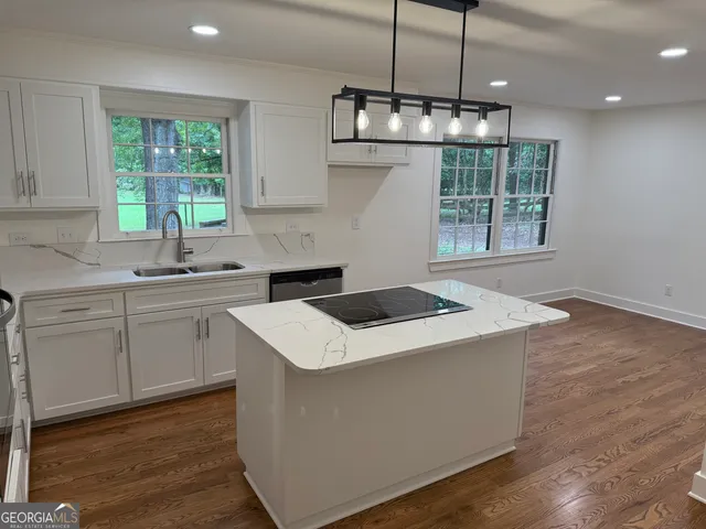 a kitchen with a stove a sink and a refrigerator